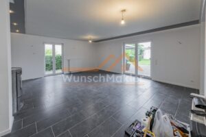 offener Wohn-/Essbereich mit Kamin und Zugang zur Terrasse